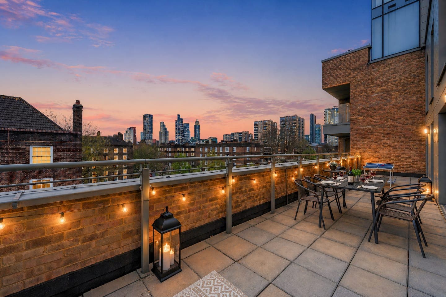 Large private terrace at sunset with views over the London skyline